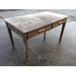 An Abbess oak desk with rectangular panelled top above two frieze drawers, raised on square tapering