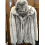 A grey fur coat with matching box hat, the lined jacket with Hong Kong Siberian Fur Store label. (