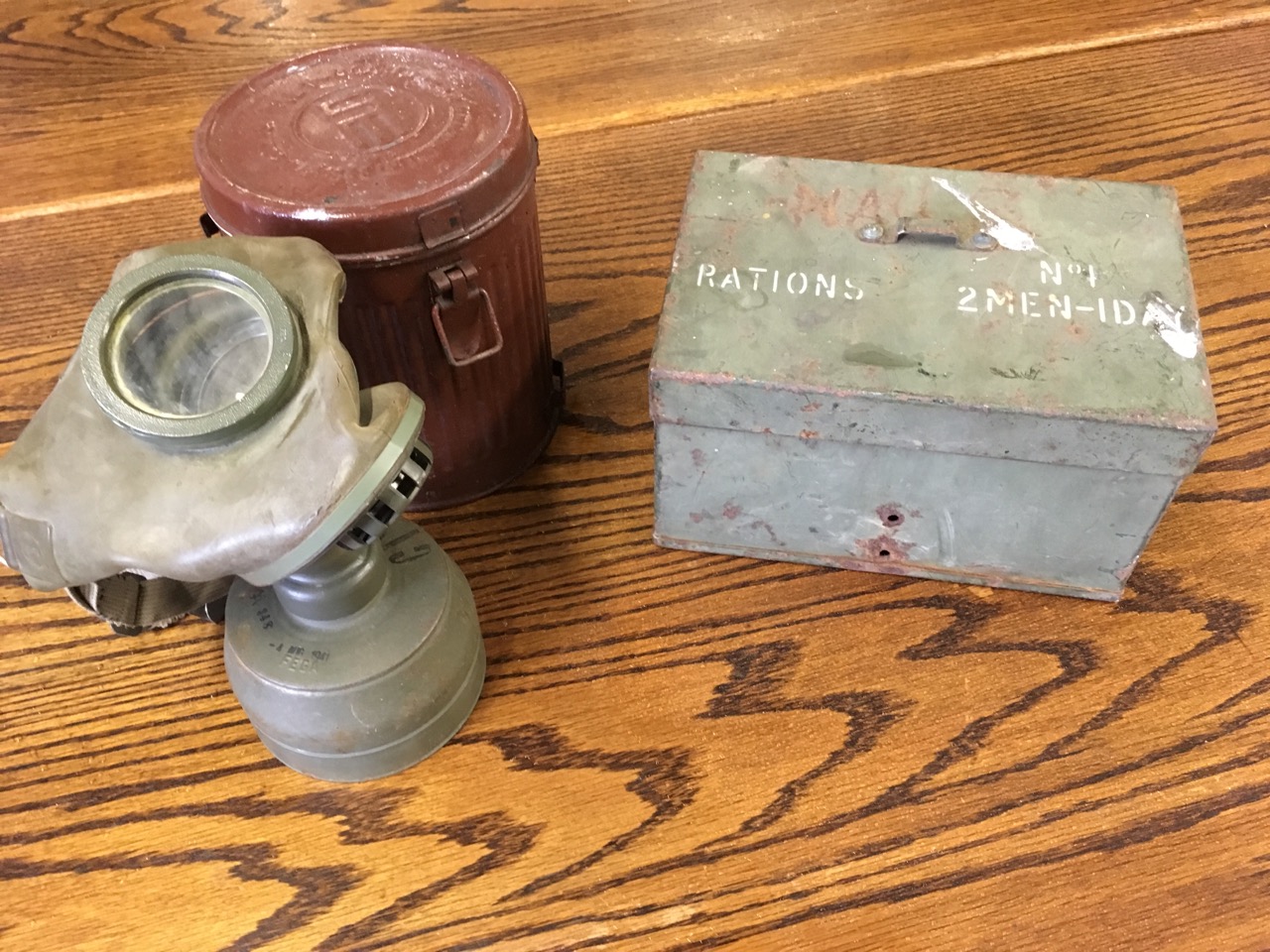 A 1941 German gas mask in original tubular ribbed can with hinged lid; and a rectangular iron box - Image 2 of 6