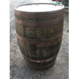 A 3ft oak barrel, the stathes bound by six metal strap bands.