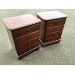 A pair of mahogany bedside cabinets, the crossbanded tops above four drawers, raised on bracket