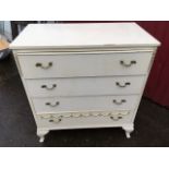 A white chest of four long drawers mounted with brass leaf handles, raised on square stub cabriole