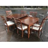 A mahogany dining room suite, the extending panelled-top dining table with two leaves on square