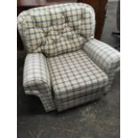 A modern tartan upholstered wingback armchair, with loose cushions and sprung seat raised on