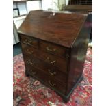 A small George III mahogany bureau, with crossbanded fallfront enclosing a fitted interior of