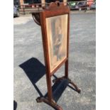 A nineteenth century rosewood firescreen, with sliding panel in frame mounted with rectangular