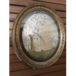 An oval Victorian crewelwork tapestry on silk ground depicting an exotic bird in tree and vase of