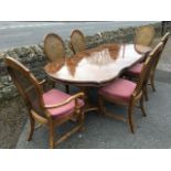 A reproduction French walnut dining table & chair set, the extending table with two leaves on