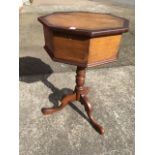 A Victorian octagonal oak workbox table, the mahogany crossbanded box having fitted interior, raised