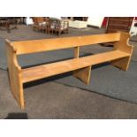 An 8ft hardwood pew with open back having solid plank seat, with moulded shaped ends. (8ft)