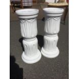 A pair of white glazed jardiniere stands, with leaf style decoration to columns, raised on moulded