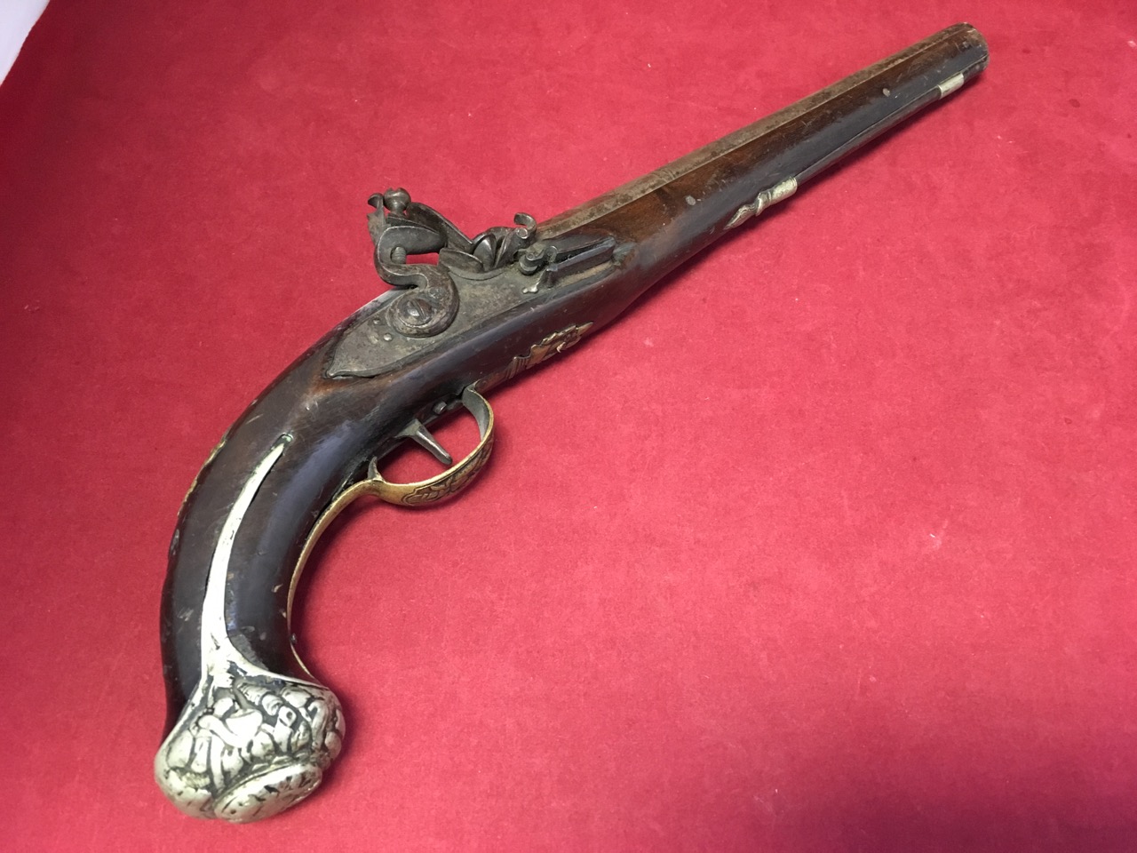 A flintlock pistol with London marked to lock, having walnut stock and brass trigger guard, the