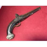 A flintlock pistol with London marked to lock, having walnut stock and brass trigger guard, the