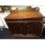 A Victorian mahogany chiffonier, with scroll carved back on a rectangular moulded top, having two