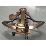 A brass sextant by Ewer & Leahy of Cardiff, the instrument with mahogany handle, having fine