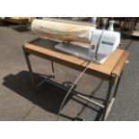 A Morphy-Richards ironing machine, the electric rotor mounted on rectangular table with foot