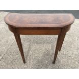 A 'D' shaped walnut quarter veneered hall table with crossbanded top, raised on square tapering