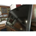 A Bose flatscreen TV with AVM control console, audio calibration system, remote, wallfixing