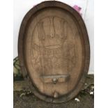 An oval German carved oak panel formed from a barrel top with copper bands, commemorating