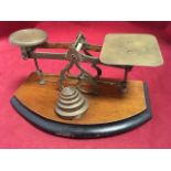 A set of Victorian brass postal scales, the balance complete with graduated weights on bowfronted