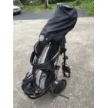 A set of Slazenger left-handed golf clubs, complete with trolley, bag on stand, covers, etc. (A