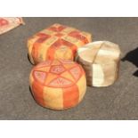 Two North African leather pouffes - one square and another circular; and another skin covered. (3)