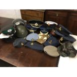 A collection of military caps, berets, a helmet, etc. (17)