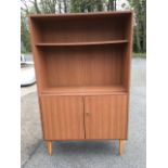 A laminated open bookcase with adjustable shelves above cupboards, raised on angled legs.