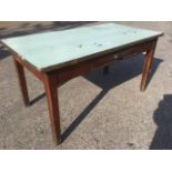 A nineteenth century pine table with formica to top, having frieze drawer, raised on square tapering