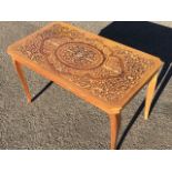 An Italian marquetry style coffee table with penwork to foliate scrolled top, having canted