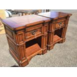 A pair of architectural style chunky mahogany bedside cabinets, with boarded panelled tops above