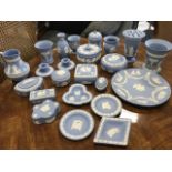 A collection of blue Wedgwood jasperware - vases, trinket pots & covers, platters, boxes, jam