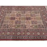 An Egyptian oriental style Valby Ruta rug, woven with rectangular field of floral panels framed by