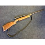 A German .22 Feinwerkbau-Sport air rifle with beech stock and leather sling, fitted with SMK 4 x