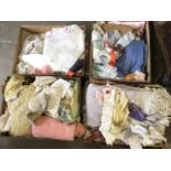 Four boxes of miscellaneous textiles - gloves, silk scarves, embroidery, bed covers, tablecloths,