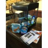 A bowfronted glass aquarium, the Aqua Start 320 model complete with lights, pump, fish food,