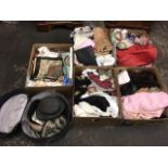 Five boxes of miscellaneous textiles and a hat case with hats, including embroidery, damask, bags,