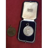 A cased hallmarked silver Northumbrian pipes medal dated 1936, presented by Viscount Ridley,