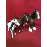 A Beswick shire horse; a piebald Beswick pony; and a glazed bay Beswick horse with pricked ears. (