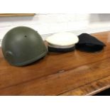 A 1985 NATO helmet; an HMS Claverhouse naval cap; and a porters railway cap. (3)