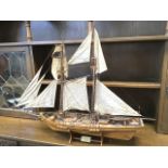 A wood model of the Victorian clipper Harvey, the tall ship with full sails, rigging, canons,