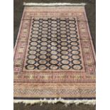 An oriental chenille style rug woven with blue field of sixty five rectangular lozenges framed by