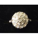 A 9ct gold diamond cluster ring, the stones set as a dome flanked by leaf shoulders, mounted on a