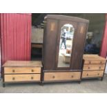 An oak three-piece bedroom suite, the chest with three drawers, the wardrobe with bevelled mirror