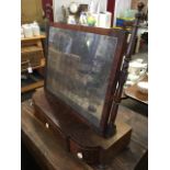 A nineteenth century mahogany dressing table mirror with rectangular framed plate on angled ring-