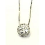 An 18ct gold diamond pendant, the round brilliant claw set diamond, framed by a halo of diamonds,