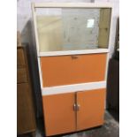 A 60s kitchen cabinet with sliding acid etched glass door (one absent) above a drop-down compartment