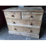 A Victorian pine chest of drawers, with two short and two long knobbed drawers, raised on moulded