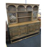 A carved oak dresser, the back with long shelf framed by columns with arched flowerhead carved