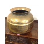 A large nineteenth century brass jardinière of ribbed ball form, having angled flared rim.